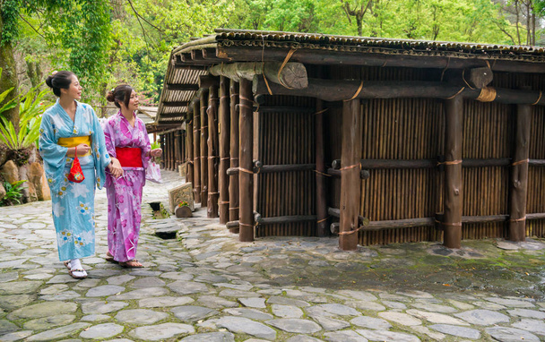 Asian woman walking near  Japan wood house  - Foto, imagen