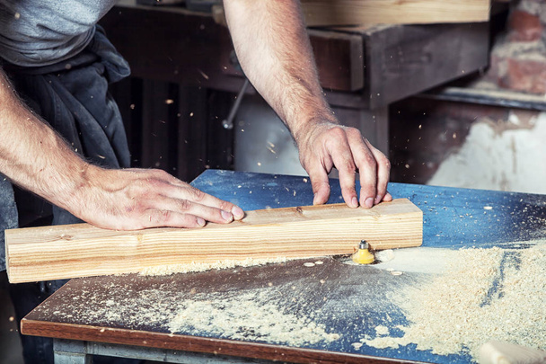 man equals a wooden milling machine - Fotó, kép