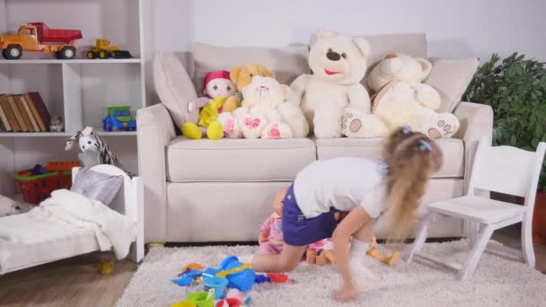 Cute kid girl playing with toy at home - Materiał filmowy, wideo