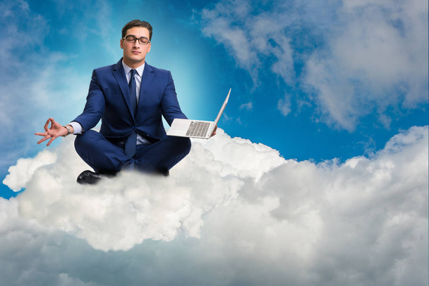 Businessman working on laptop in the sky - Photo, Image