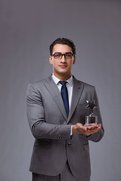 Businessman holding star award in business concept - Fotó, kép