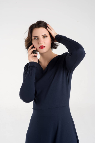  Beautiful girl posing in a blue dress calling on the phone - Foto, immagini