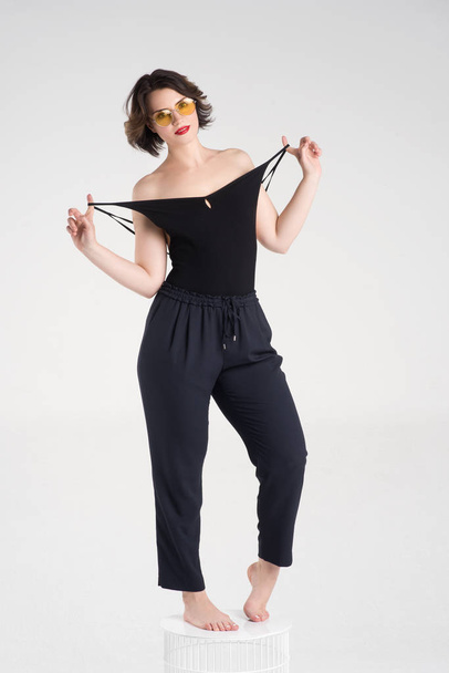  Beautiful girl posing in a black T-shirt and glasses - Valokuva, kuva
