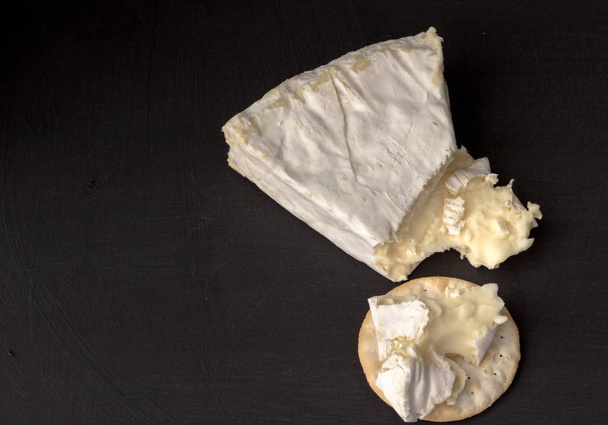 Brie type of cheese. Camembert cheese. Fresh Brie cheese wedge  - Photo, Image