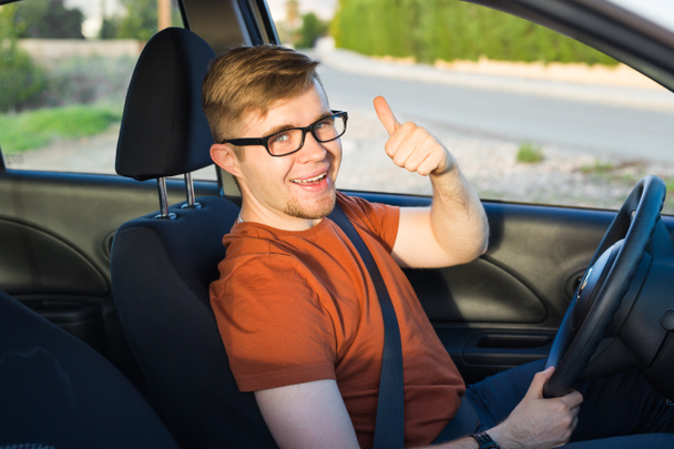 Happy car owner is showing thumbs up inside his new car - Photo, Image