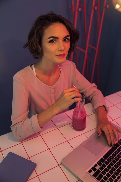Smiling pretty girl drinking smoothie cocktail - 写真・画像