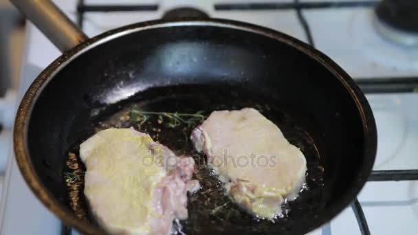 Raw meat is put in a frying pan. Steak fry in a frying pan. - Footage, Video