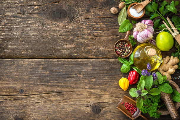 Fresh herbs and spices on wooden table - Photo, image