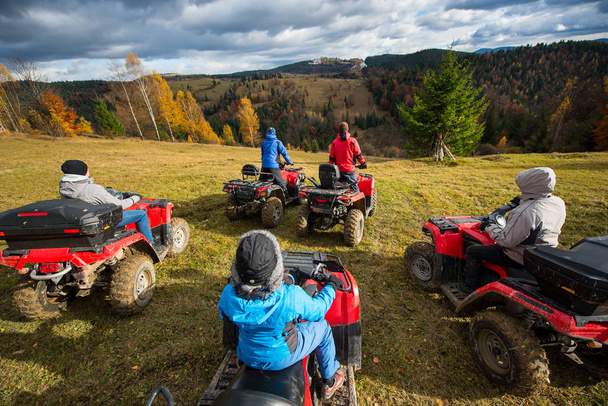 people riding a off-road vehicles on hill  - Photo, Image
