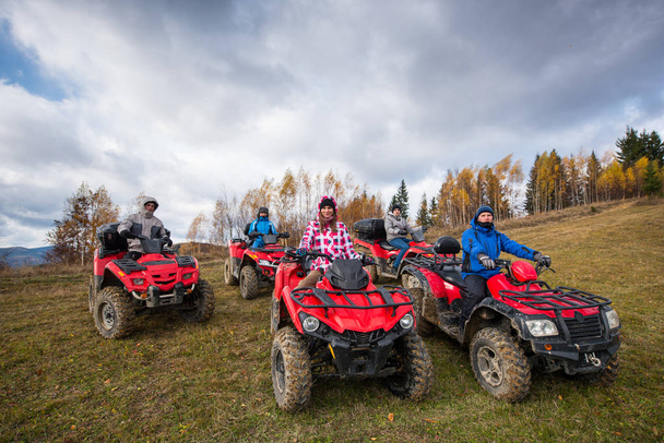 people  on red atv off-road vehicles  - Photo, Image