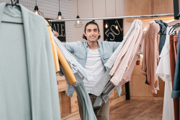 man working with clothes in boutique - Photo, Image