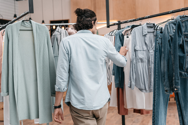 man working with clothes in boutique - Photo, Image