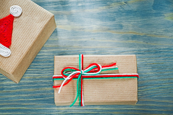 Wrapped Christmas gift boxes on wooden board holidays concept - Valokuva, kuva