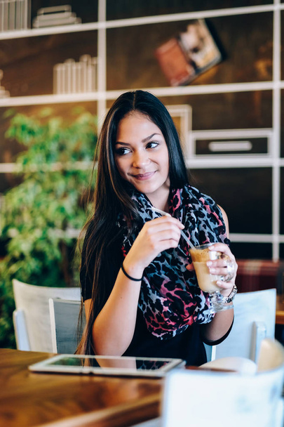 Beautiful girl drinking ice mocha shake in a cafe - Photo, Image