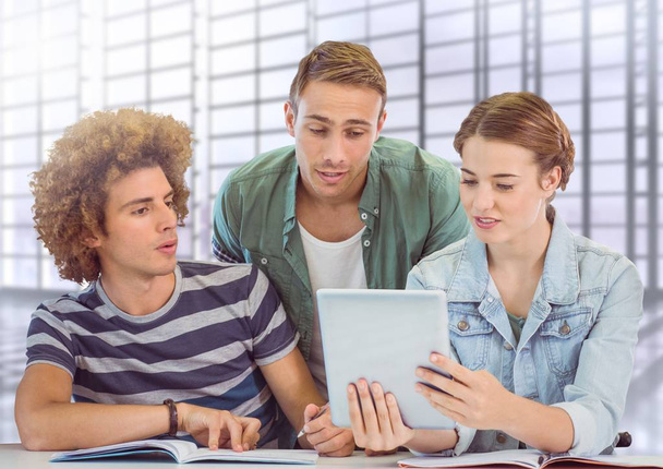 Students looking at tablet in front of blurred background - Photo, image