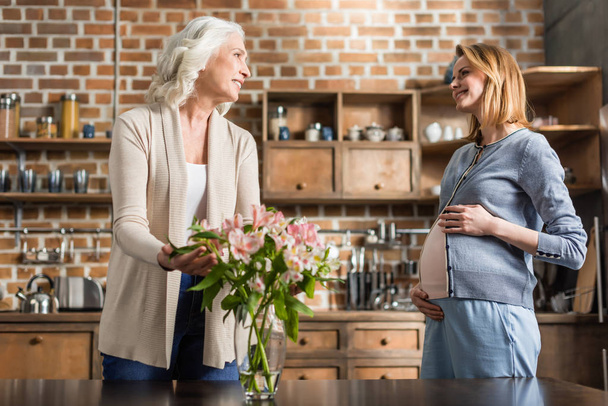 pregnant woman and her mother on kitchen - Foto, Imagem