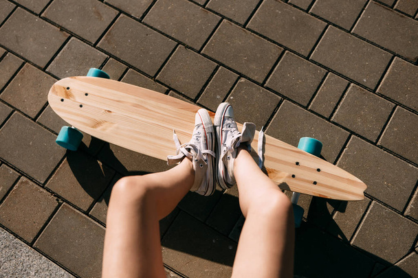 Girl with wooden longboard skateboard. - 写真・画像