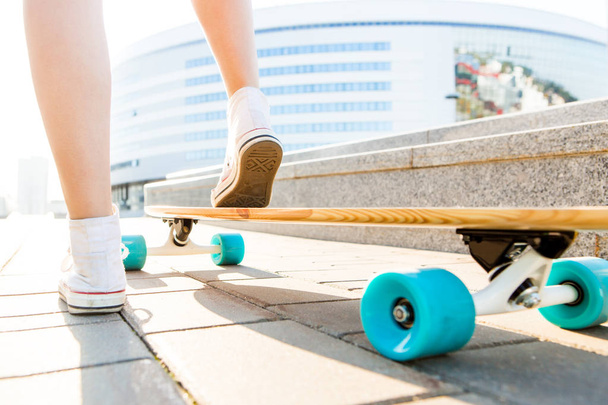 Girl with wooden longboard skateboard. - Photo, image