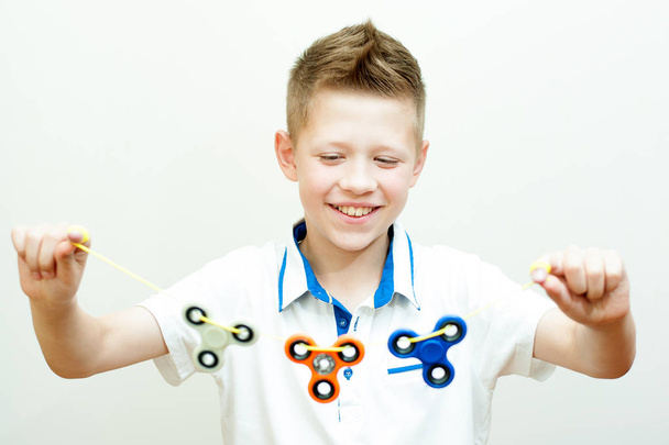Boy holds a rope with three spinners - 写真・画像