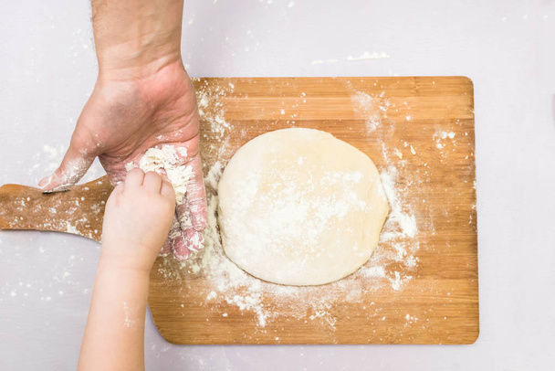 Children and dad hands rolled dough - Foto, Bild