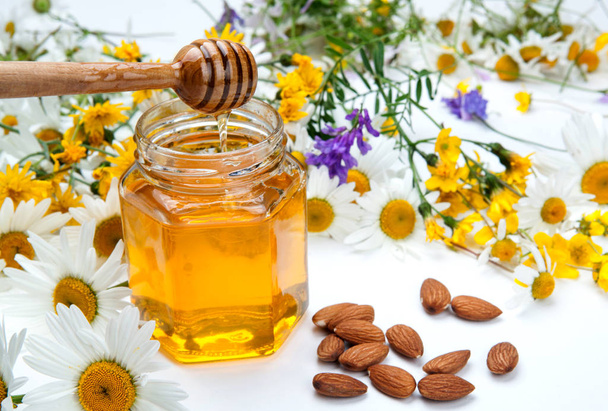 Bodegón de miel fresca y flores
 - Foto, Imagen