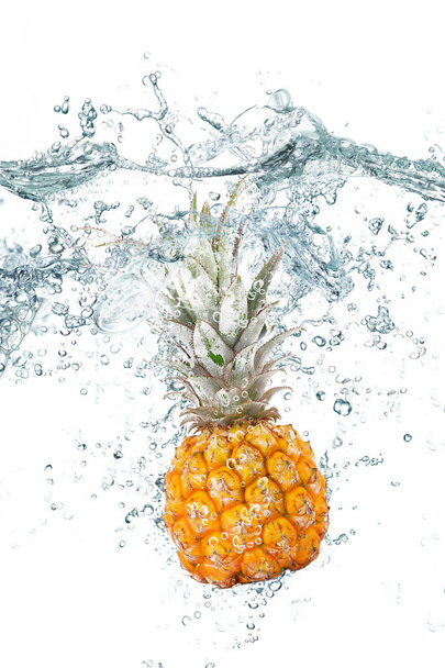 fresh pineapple falling in water - Фото, изображение
