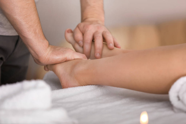 Young woman having foot massage - Fotó, kép