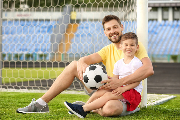 Dad and son with soccer ball - 写真・画像