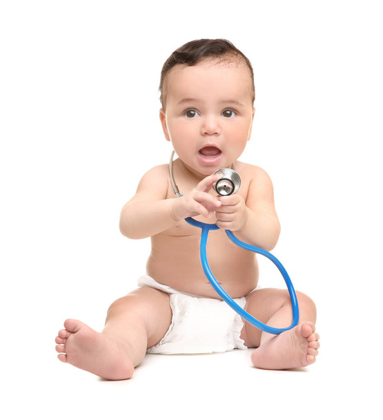 Cute little baby with stethoscope on white background. Health care concept - Fotó, kép