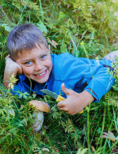 Boy with wild mushroom found in the forest - Фото, изображение