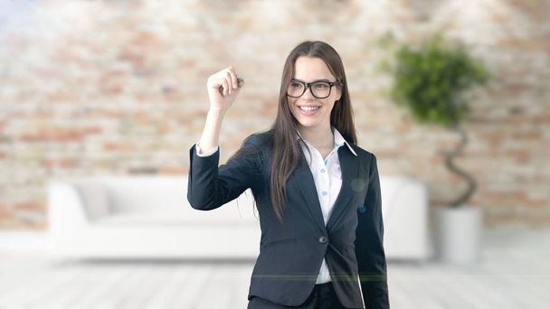 Young beautiful business woman and creative designer standing over blured interior background - Fotoğraf, Görsel