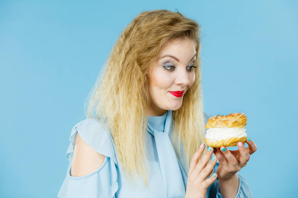 Funny woman holds cream puff cake - Fotografie, Obrázek