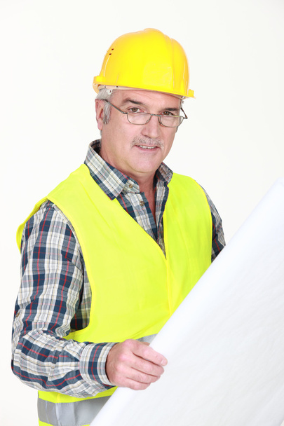 A mature foreman checking plans. - Foto, afbeelding