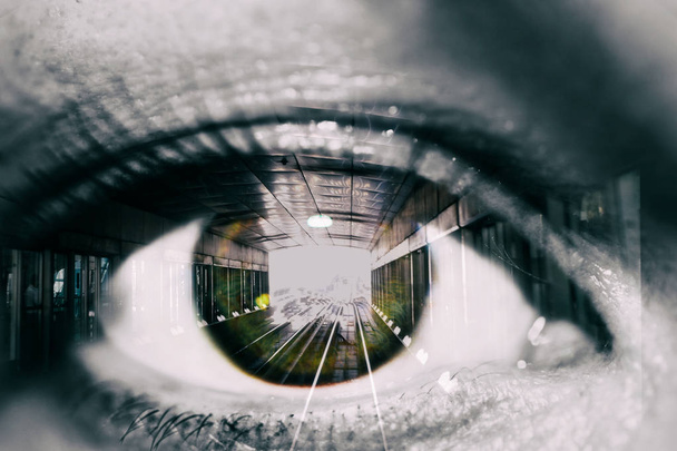 Macro picture of Double exposure of the female eye and tunnel with train car in subway - Фото, зображення