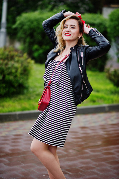 Portrait of a beautiful bridesmaid in a pretty striped dress tou - Fotografie, Obrázek