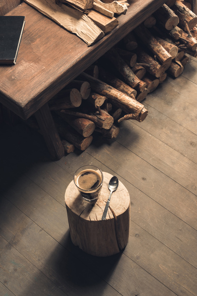 Glass of coffee and spoon on wood - Photo, Image