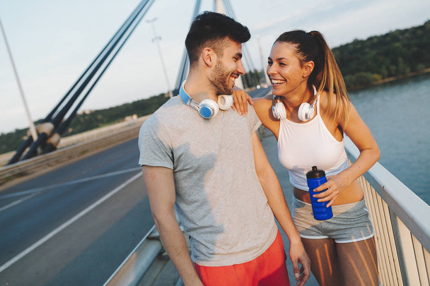Portrait of man and woman during break of jogging - Foto, Imagem
