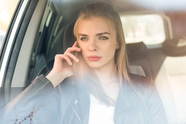 woman talking on smartphone in car  - Photo, Image