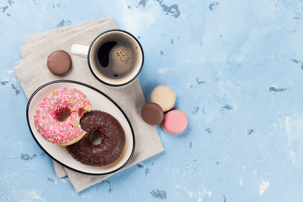 Coffee cup and colorful donuts - Photo, Image