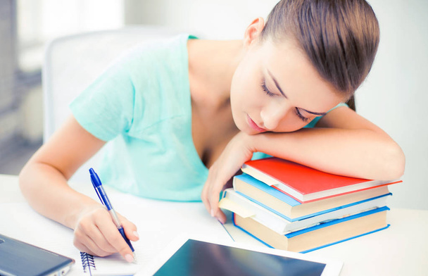 tired student sleeping on stock of books - Photo, image
