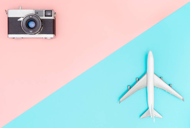 Samolot zabawki i kamery na tle różowy i niebieski dla podróży elegancki koncepcja - Zdjęcie, obraz