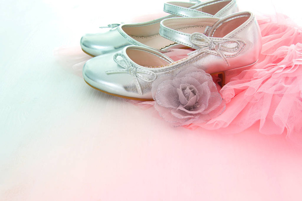Vintage tulle pink chiffon dress and silver shoes on wooden white floor - Foto, imagen