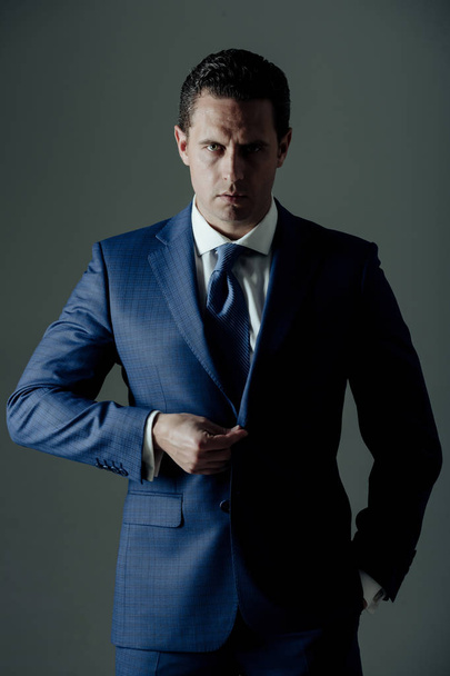 business fashion, businessman buttoning button on elegant blue formal suit - Foto, Bild