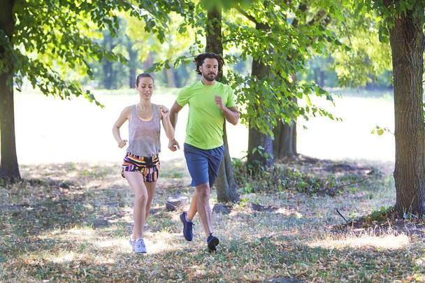 Jovem casal correndo no parque
 - Foto, Imagem