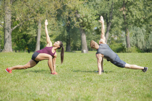 Young couple training in park - Photo, Image
