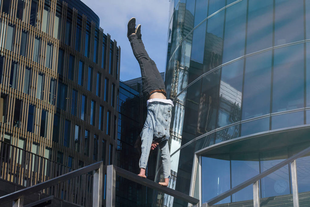 Young man doing handstand in the city - Фото, зображення