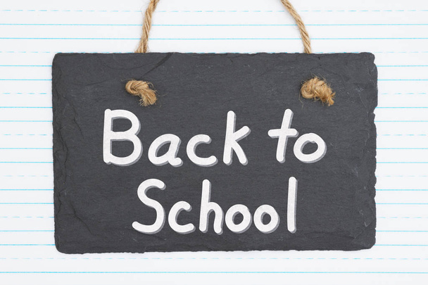 Back to School message on a weathered old chalkboard - 写真・画像