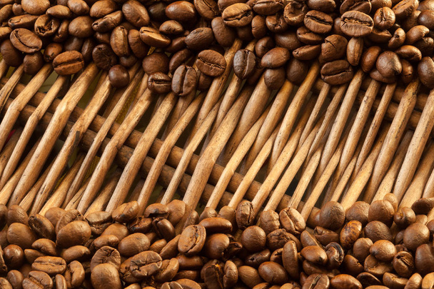 Coffee beans on straw - Фото, изображение