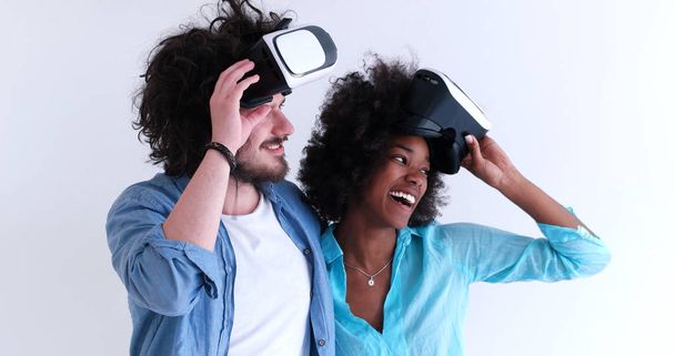 multiethnic couple getting experience using VR headset glasses - Foto, immagini