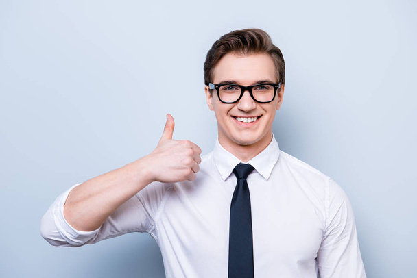 Successful excited young guy in glasses and formal wear is stand - Foto, Imagen